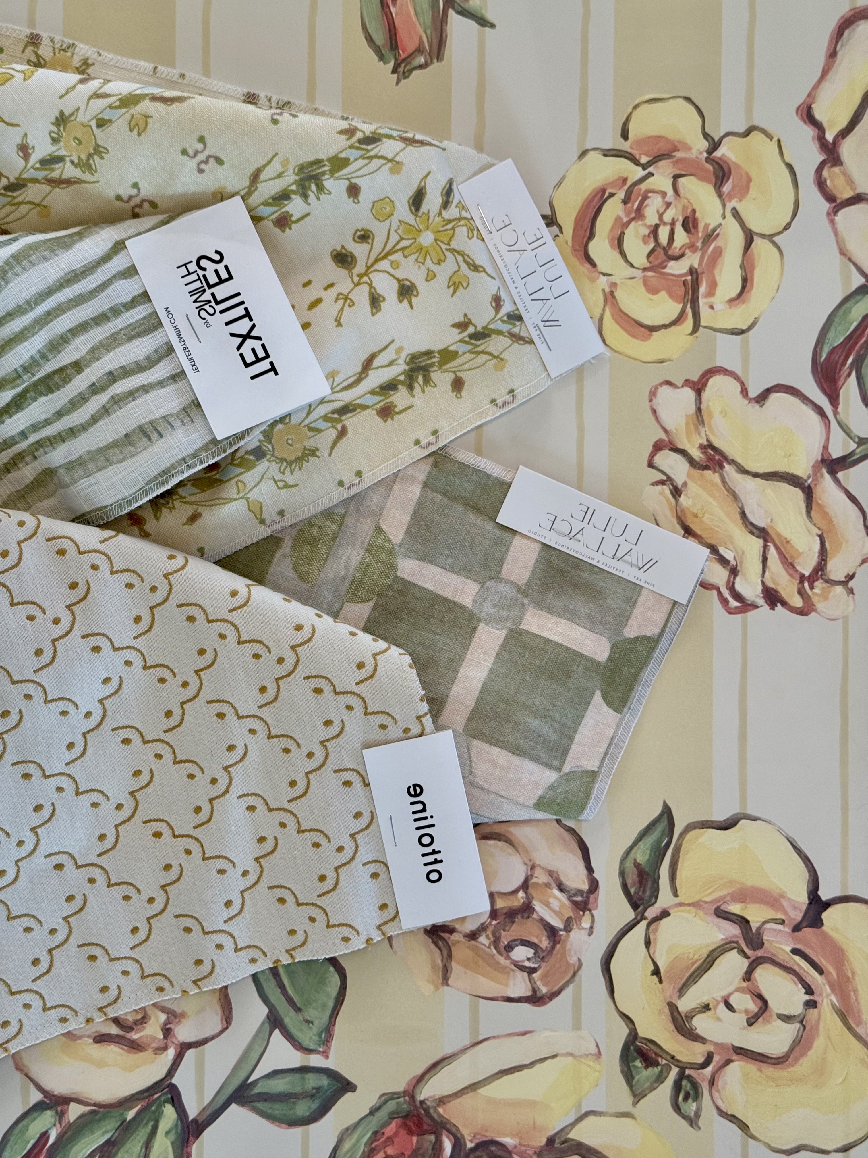 Designer fabric and trim samples arranged for a project